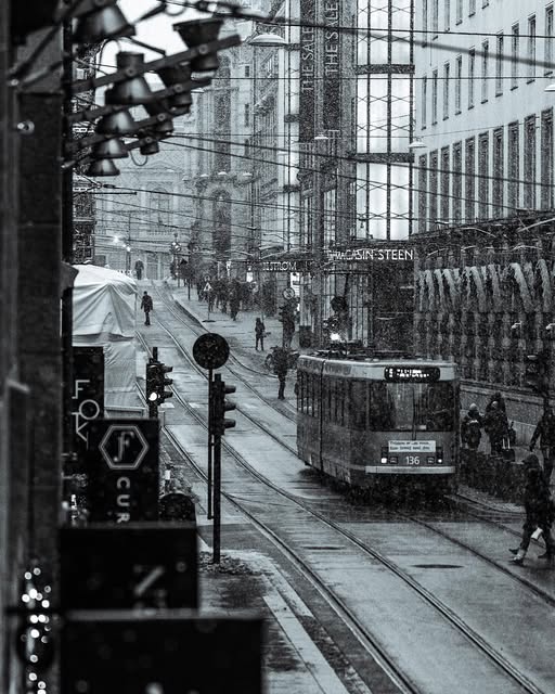 Black and white street scene with a tram